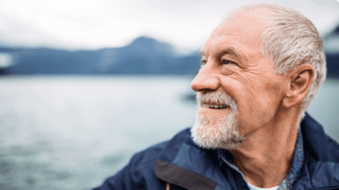 senior man with the sea as background
