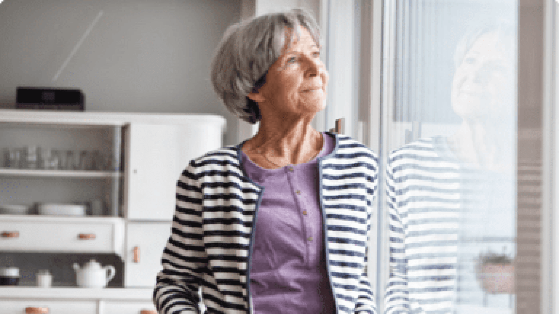 senior woman looking at window