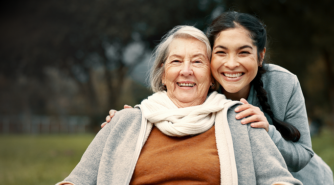 young woman holding an elder woman