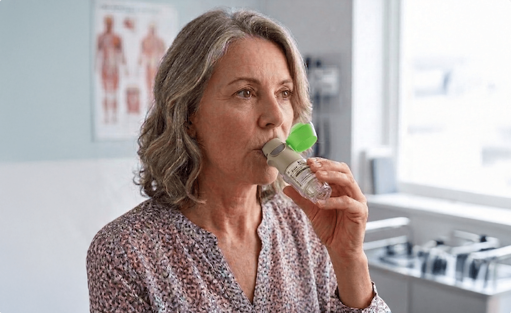 Woman using Stiolto's respimat inhaler spray
