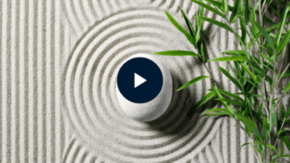 Zen sand garden with a stone and bamboo