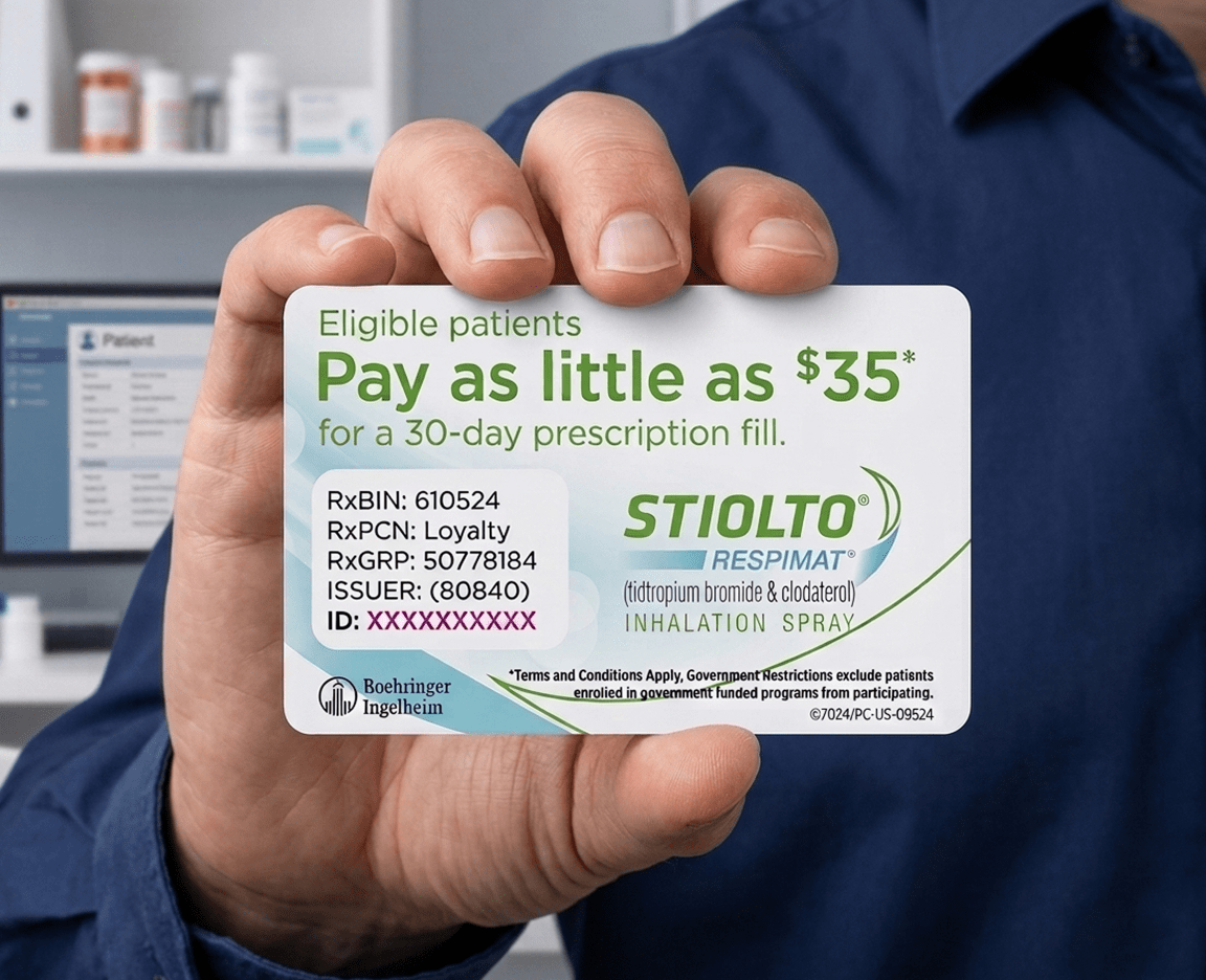 A hand holding a Stiolto Respimat savings card.