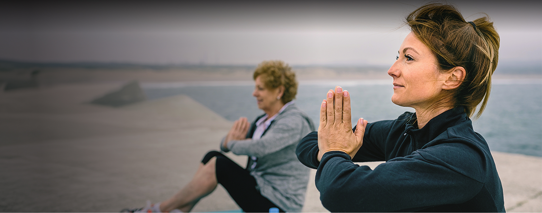 two ladies doing yoga